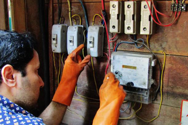 An electrician checking power supply and repairing the electric supply unit.